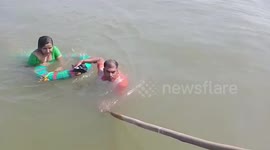 Woman in India saved from drowning by police after falling from bridge