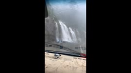 Hundreds of small waterfalls pour down roads after days of heavy rain in Vietnam