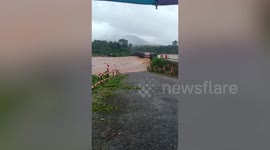 Bridge submerged by swollen river after heavy rain in southern Thailand
