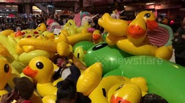 Rubber duck rebels! Thai protesters bring inflatable toys to protest after PM's court case