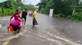 Villagers catch fish on flooded roads in southern Thailand