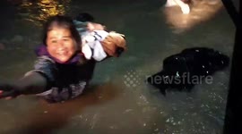 Rescuers drive tractor through Thailand floods to reach stranded residents