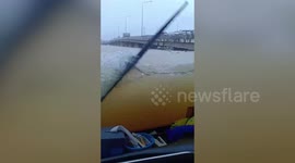 Bus driver battles through deep floodwater that has killed at least five in southern Thailand