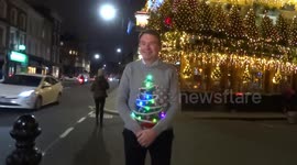 The Churchill Arms manager James Keogh is positing for photographs outside the glittering pub after Christmas Lights switch-on 2020