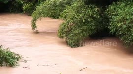 Dramatic moment man battles to save home washed away by floods in southern Thailand