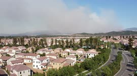Smoke rises above Irvine, California as Bond Fire prompts evacuations