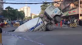 Mixer truck swallowed by sinkhole that opened up on southern China road