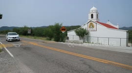 Cars traveling in front of a church by road in the Sierra de Mazocahui Sonora. highway