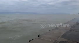 Waves crash into the the banks of Lake Michigan splashing locals