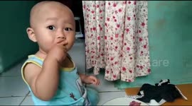 Adorable eight-month-old child tries out mango pieces for the first time