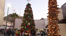 Children and adults take photos of the new Christmas tree in the center of Hermosillo, Mexico. Christmas lights