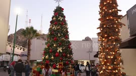 Children and adults take photos of the new Christmas tree in the center of Hermosillo, Mexico. Christmas lights