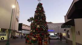 Children and adults take photos of the new Christmas tree in the center of Hermosillo, Mexico. Christmas lights