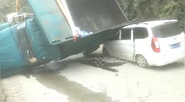 Motorist narrowly escapes death after truck flips onto car in southern China
