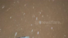 Amazing footage of giant snowflakes falling in the streets and mountains of Andorra, decorated with dazzling Christmas lights