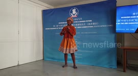 African woman sings in Chinese