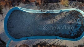 Aerial view of a pool, swimming pool and spa in deterioration due to being abandoned and burned, located in the rural area of Real del Alamito in Sonora, Mexico