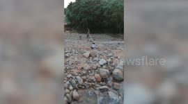Dedicated schoolboys use zipline to cross steep ravine after being cut off by floods in Thailand