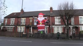 Giant six-metre Santa Claus pops up in English street to bring cheer to community
