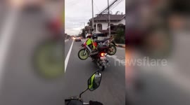 Motorcycle rider carries his friend's broken-down scooter on the back of his own bike for 70 miles