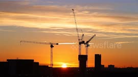 Sunrise behind tower cranes in Leeds