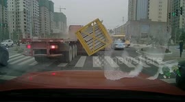 Crate of cement boards flatten vehicle after falling off transport truck in southern China