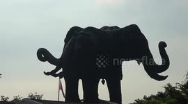 Giant three-headed elephant building towers over surroundings in Thailand