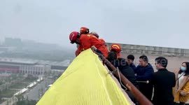 Firefighters rescue man threatening to jump off hotel roof in China