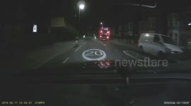 Double decker bus overtakes cyclist on the other side of the road.