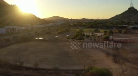 El Carcamo dirt sports fields in La Sauceda on December 10, 2020 in Hermosillo, Mexico. Baseball fields with the sun at sunset over the Cerro de la Campana.
