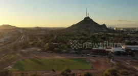 landscape City, El Carcamo dirt sports fields in La Sauceda on December 10, 2020 in Hermosillo, Mexico. Baseball fields with the sun at sunset over the Cerro de la Campana, landscape City, Sunset, Hill