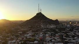 Aerial view of Cerro de la Campana at sunset and the Hacienda de La Flor, Revolucion colonies on December 10, 2020 in Hermosillo, Mexico. .