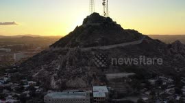 Aerial view of Cerro de la Campana at sunset and the Hacienda de La Flor, Revolucion colonies on December 10, 2020 in Hermosillo, Mexico. .