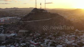 Aerial view of Cerro de la Campana at sunset and the Hacienda de La Flor, Revolucion colonies on December 10, 2020 in Hermosillo, Mexico. .