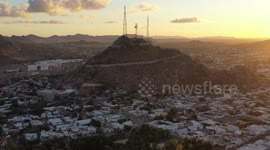 Aerial view of Cerro de la Campana at sunset and the Hacienda de La Flor, Revolucion colonies on December 10, 2020 in Hermosillo, Mexico. .