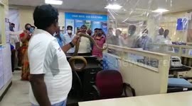 Rescuer removes large snake from branch of bank in southern India
