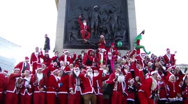 ARCHIVE: Many Santa Clauses celebrate Christmas on Nelson's Column at Trafalgar Square, London, UK
