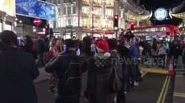 Londoners sing 'Auld Lang Syne' at Oxford Circus silent disco