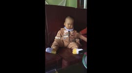 Baby boy fails to fight off the urge to sleep while being fed by his mother