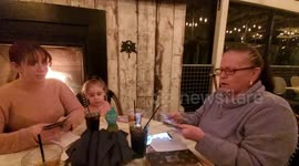 Son surprises mom, sister with envelope filled with cash to spread Christmas spirit