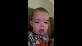 Baby Elias making faces and sticking his tongue out