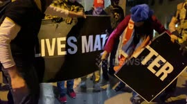 Proud Boys and Trump supporters rip apart Black Lives Matter banner outside DC church