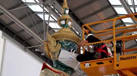 Buddhist statues at Thai airport giant face masks as tourists begin returning to the country