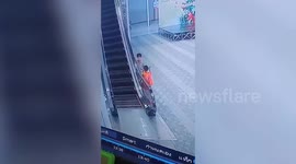 Heart-stopping moment toddler is dragged up escalator handrail