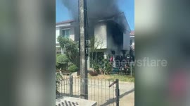 Firemen rescue two trapped dogs from burning house in Thailand