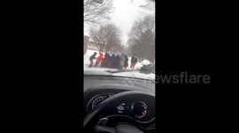 US: Children Helps Car Stuck In Snow In Baltimore, Maryland