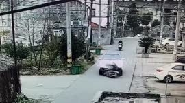 Scooter rider dragged along road after falling in front of car in China
