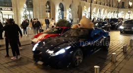 Giant Teddy bear (french Nounours des Gobelins) in a Ferrari and luxury cars decorated for Christmas. Place Vendome, Paris. 18dec2020