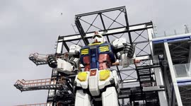 Watch a giant Gundam robot raise its arms and clench fists in Yokohama, Japan