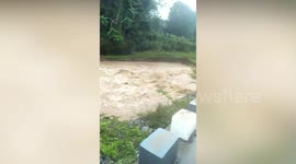 Rising River Almost Covers Bridge In The Philippines